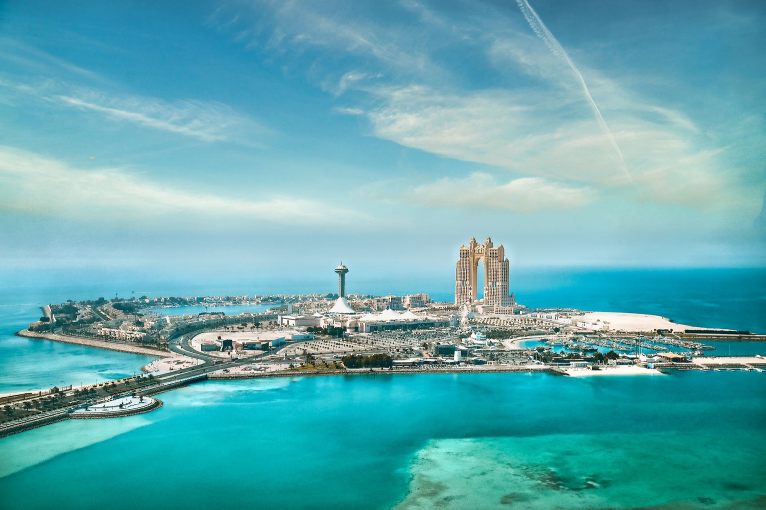 Aerial view of Abu Dhabi's waterfront and the turquoise shallows around its islands